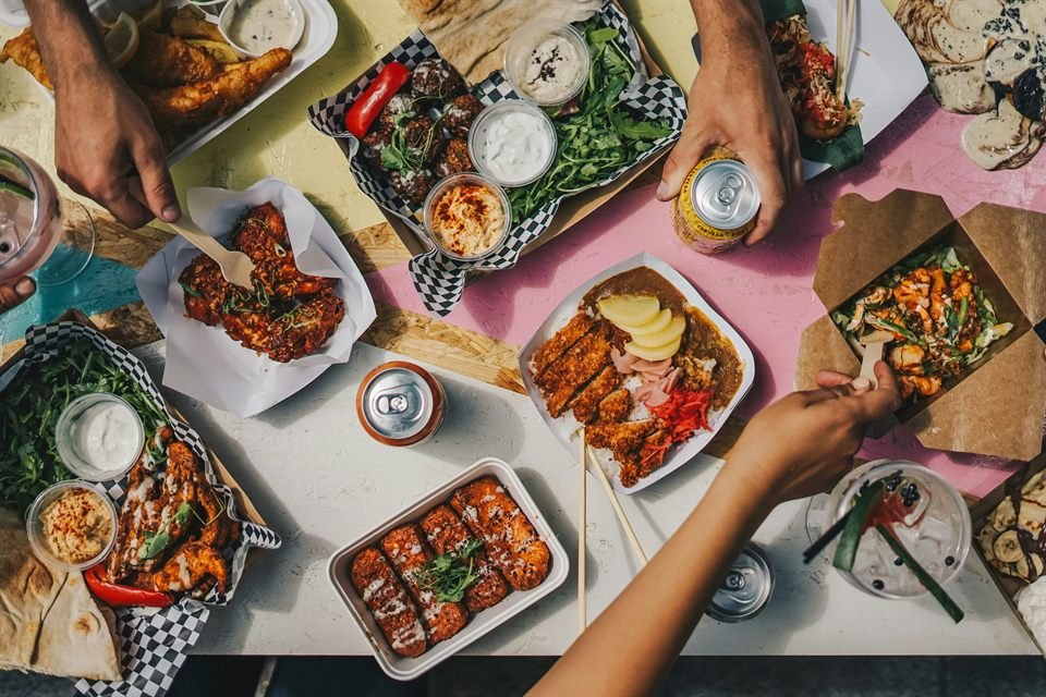 A spread of takeaway food in boxes and paper